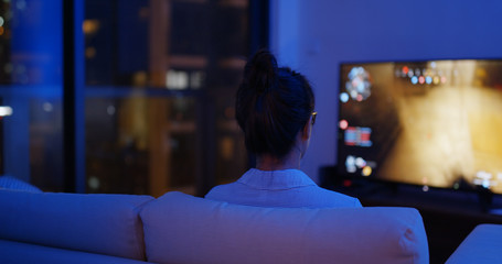 Wall Mural - Woman play tv game at home in evening