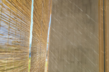 Poster - Selective focus Pattern of bamboo blinds curtain texture background with sunlight shadow on cement wall