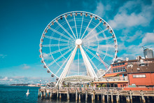 Seattle Famous Ferris Wheel In The Harbor Clouds In Sky Blue