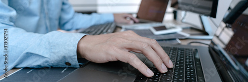 Fotografía Programmer working On Computer In IT Office Typing Data Coding in software and checking code on computer screen