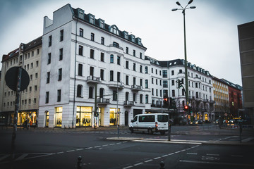 Street in Berlin in evening with historical buildings with shops and road. Travel an tourism in Berlin.