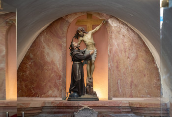 The statue of Elijas the prophet and crucified Jesus Christ stands in a niche above the entrance to the grotto of the Milk Grotto Church in Bethlehem in Palestine