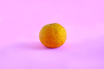 Wall Mural - Orange isolated on the pink scene or pink background