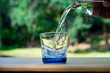 Pouring pure water in to the glass make spread of water crystal bubble with background nature