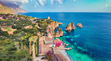 View from flying drone. Picturesque spring scene of Tonnara di Scopello. Colorful landscape of Sicily, Italy, Europe. Wonderful morning seascape of Mediterranean sea. Traveling concept background.