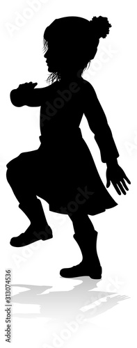 A child in silhouette playi...