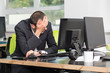 © A Stock Studio - Sad businessman sitting in front of monitor computer in the office. Stressed work.