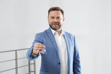 Wall Mural - Male real estate agent holding key in new apartment