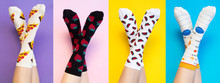 Female Legs In Colorful Socks On Colored Background
