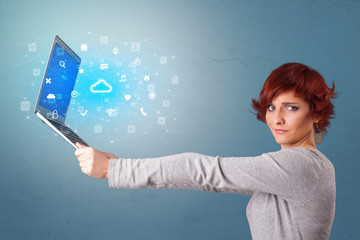 Wall Mural - Woman holding laptop projecting notifications, symbols and information based on cloud technology system