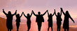 © May Chanikran - Business people united hands and raised hands up together with spirit teamwork on the top of mountain for banner.