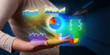 © ra2 studio - Hand holding diagrams and resultus in his hand, profitable business concept