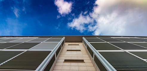 In modern building with cloudy sky behind