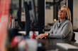 © Westend61 - Happy mature businesswoman sitting at desk in office
