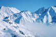 © Roman Babakin - Landscape in Zillertal Arena ski resort in clouds in Tyrol at Mayrhofen in Austria in winter Alps. Alpine mountains with white snow and blue sky. Downhill peaks at Austrian snowy slopes.