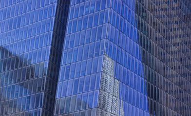 Wall Mural - glass windows skyscraper exterior background surface with reflection modern city center business building urban landmark view