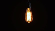Incandescent Light Bulb In Dark Background