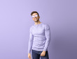 © Pixel-Shot - Young man with stylish sunglasses on color background