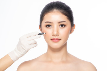 lines on face, close up, plastic surgery concept, doctor's hand in glove making marks on patient's f