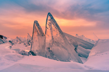 Beautiful breaking Ice on baikal lake during sunrise, Russia winter season natural landscape background