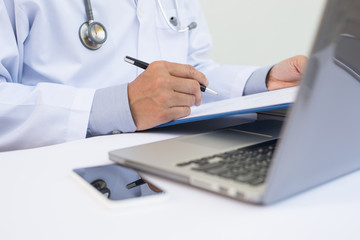 Wall Mural - Doctor working on laptop computer