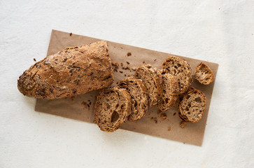 Wall Mural - Slices of rye loaf with flax seeds on a light background