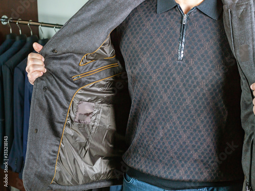 Cuadros en Lienzo A man in a short jacket shows a brown sweater with a geometrical ornament
