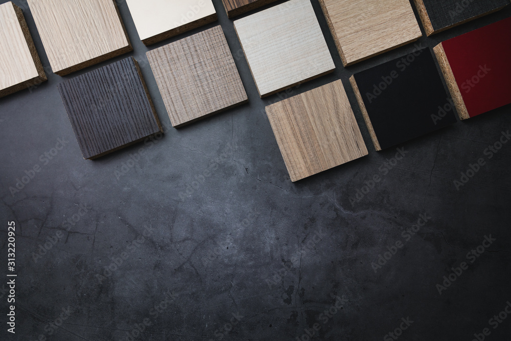 wood texture laminate furniture material samples on dark stone background with copy space - obrazy, fototapety, plakaty 