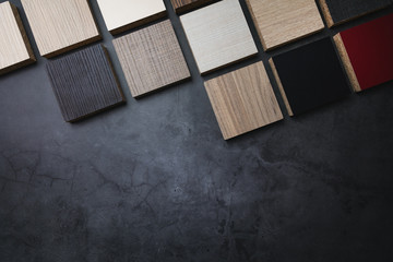 wood texture laminate furniture material samples on dark stone background with copy space