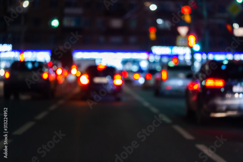 Cuadros en Lienzo Defocused picture of night street car traffic - view from road