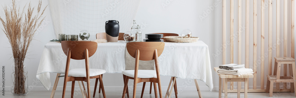 Wooden chairs and long table in living room - obrazy, fototapety, plakaty 