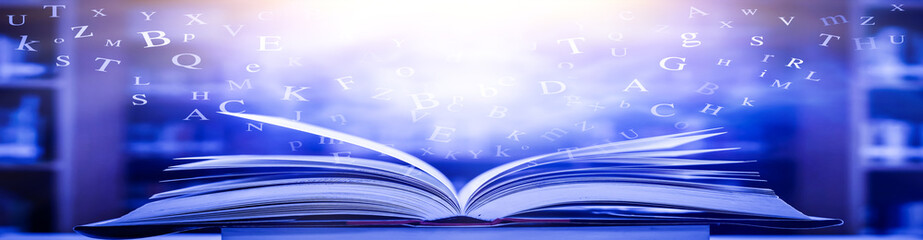 Poster - The concept of education by planting a tree of knowledge in the opening of an old book in the library and the magical magic of light that flies to the destination of success. Beautiful background