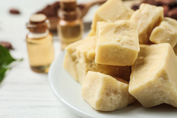 Organic cocoa butter on wooden table, closeup