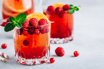 Wall Mural - Raspberry Cranberry Sangria Punch or Mojito in glass with orange slices and mint