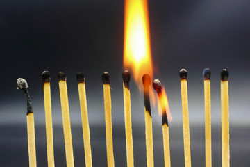 burning match on black background