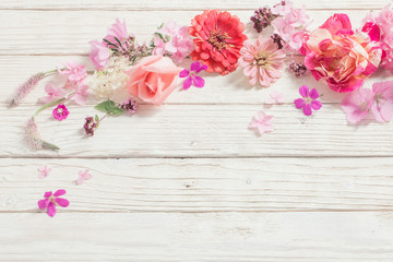 pink flowers on white wooden background