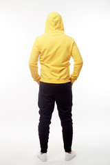 man wearing yellow hoodie isolated on white background.