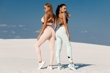 Beautiful Fitness Models In Sportswear. Couple Athletic Girls In Leggings Outdoor