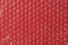 Bubble Wrap On Red Background And Plastic Texture