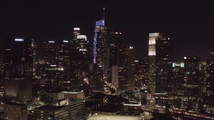 Wall Mural - Drone reversed footage of Los Angeles downtown at night