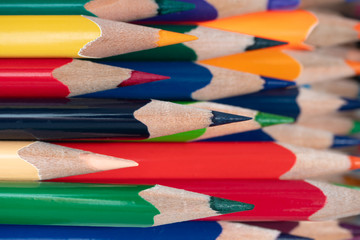 Many wooden color pencils horizontally.