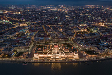 Wall Mural - Budapest, Hungary - Aerial skyline view of Budapest by night. This view includes the illuminated Hungarian Parliament building, St. Stephen's Basilica, Nyugati Railway Station and the new Puskas Arena