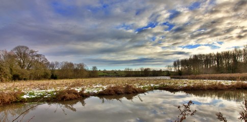 Wall Mural -  England  landscape with river and clouds