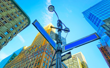 Wall Mural - Bottom up Street view on Financial District of Lower Manhattan, New York City, NYC, USA. Skyscrapers tall glass buildings United States of America. Blue sky on background. Empty place for copy space.