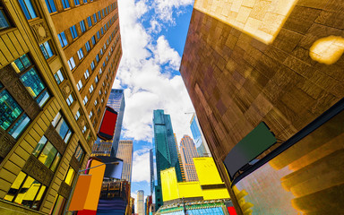 Wall Mural - Bottom up Street view on Financial District of Lower Manhattan, New York City, NYC, USA. Skyscrapers tall glass buildings United States of America. Blue sky on background. Empty place for copy space.