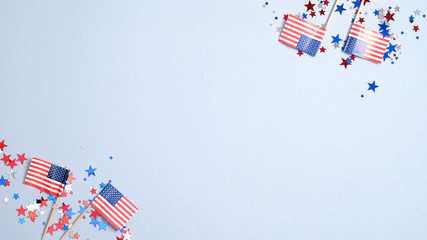 Presidents Day or Independence Day USA concept. American flags and confetti stars on blue background. Flat lay, top view.