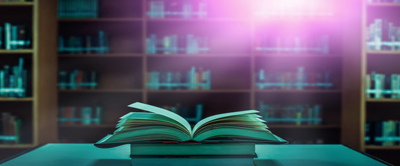 Poster - Stack of books in the library and blur bookshelf background	