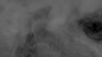 Wall Mural - White smoke on a black background slow motion. Start the movement of the cloud from the lower right corner up slowly. The concept of transitions for video editing using the alpha channel.