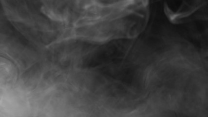 Wall Mural - Real white smoke on a contrasting black background slowly disappears.. The concept of transitions for video editing using the alpha channel. Effects for double exposure and contrast abstract.
