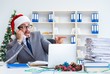 © Elnur - Young businessman celebrating christmas in the office